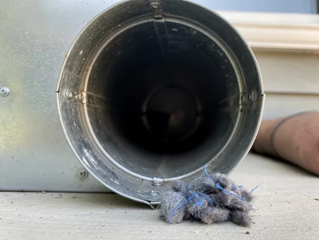 Burbank Dryer Vent Cleaning technician using specialized equipment to clear severe dryer vent blockage in Burbank